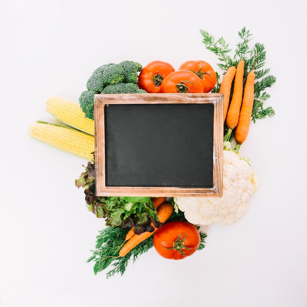 Free photo blank slate on vegetables