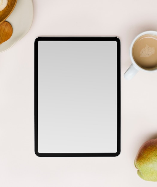 Free photo blank tablet screen flat lay by coffee cup