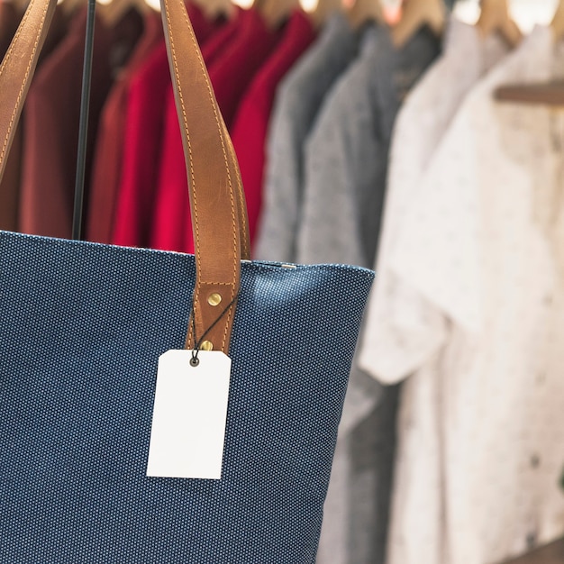 Blank tag on a tote bag in a store