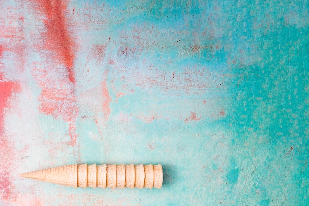 Free photo blank wafers ice cream cones gathering into each other on multicolored background