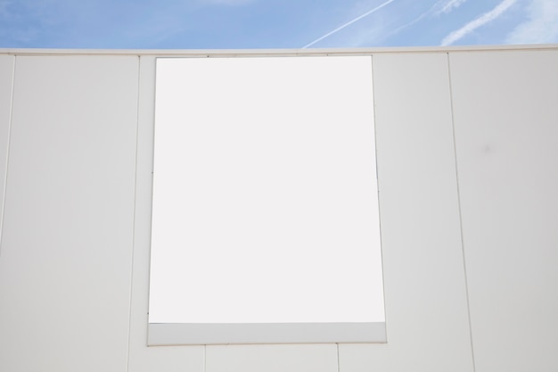 Blank white advertising billboard on wall