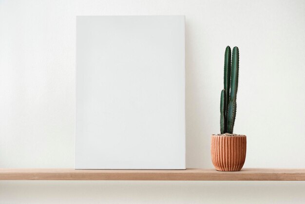 Blank white canvas on a wooden shelf