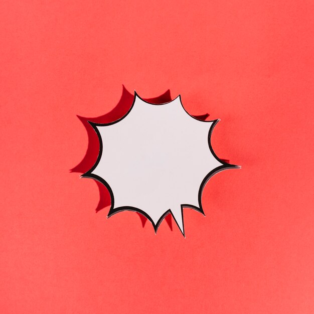 Blank white explosion speech bubble on red background