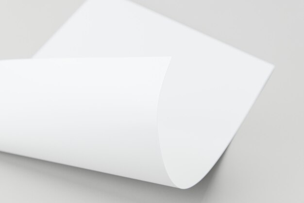 Blank white folded paper on a gray background