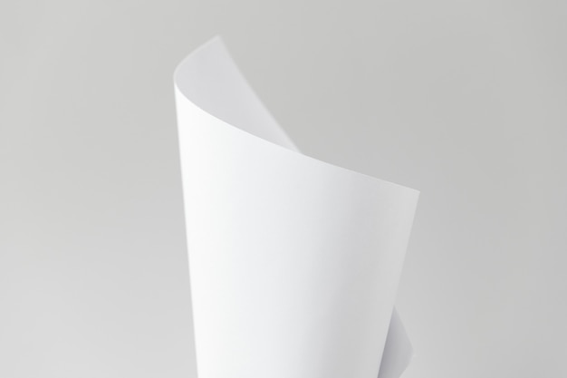 Чистый белый сложенный лист бумаги на сером