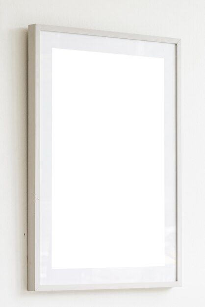 Blank white frame on white wall background
