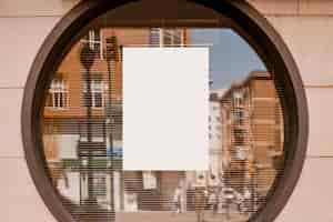 Free photo blank white paper on the circular glass window