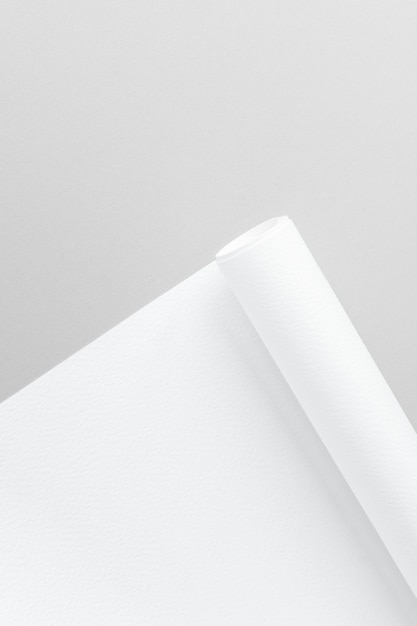 Blank white rolled chart paper on a gray background