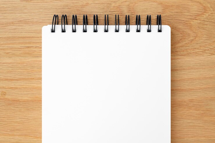 Free Photo blank white ruled notebook on a wooden table