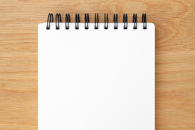 Blank white ruled notebook on a wooden table