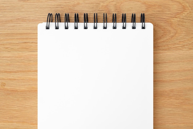 Blank white ruled notebook on a wooden table