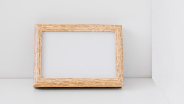 Blank wooden frame leaning against wall