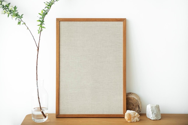 Free photo blank wooden picture frame against a white wall