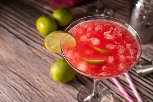 Blend of cocktails in glass with ice cubes and straws