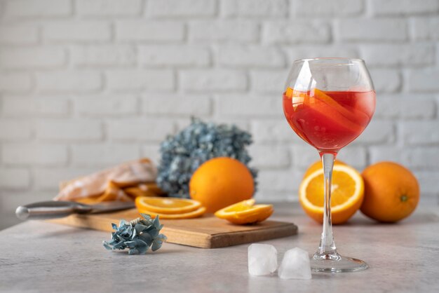 Blend of cocktails in glass with orange fruit