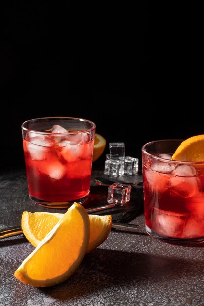 Blend of refreshing cocktails with orange fruit and ice cubes