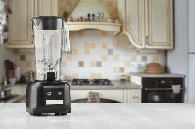 Blender and wooden table in kitchen. Do Smoothies