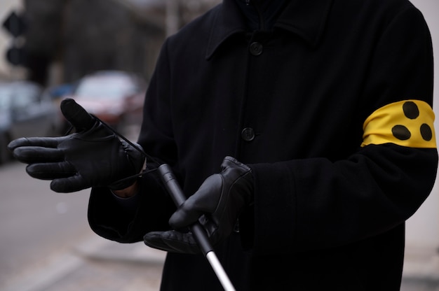 Free photo blind man fixating his walking stick to his hand