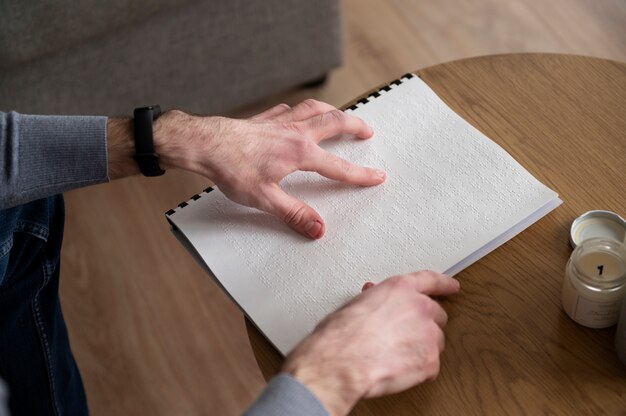 Blind man reading using the braille language