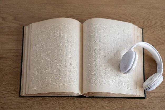 Blind people reading braille book and headphones