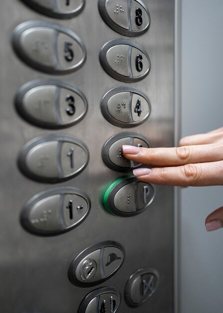 Blind person choosing floor in elevator