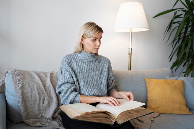 Blind person reading at home