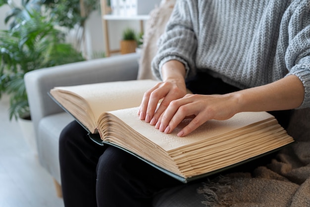 Free photo blind person reading at home