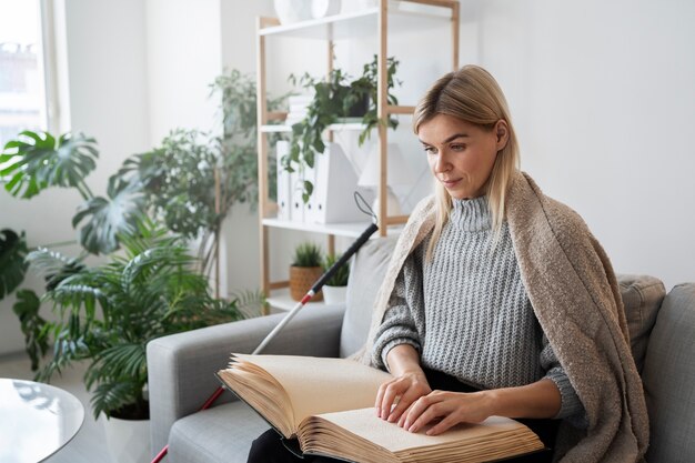 Blind person reading at home