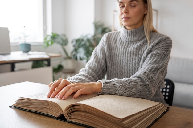 Blind person reading at home