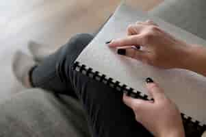 Free photo blind woman reading using the braille language