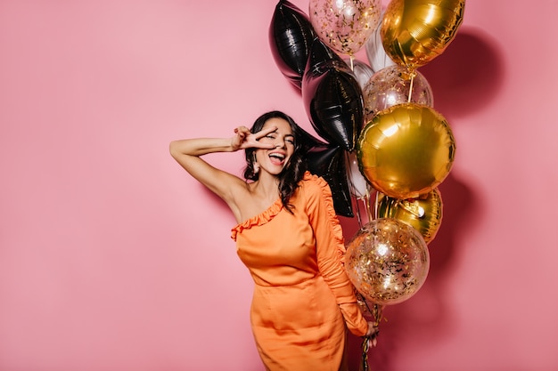 Blissful slim woman dancing at her birthday party