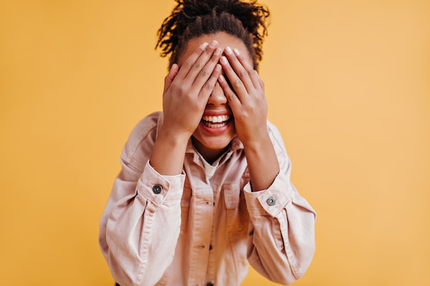 Blissful woman covering eyes with hands