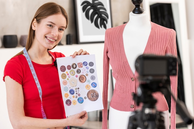 Free photo blogger holding paper with colourful buttons