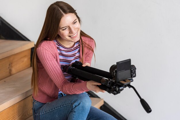 Blogger holding tripod with camera