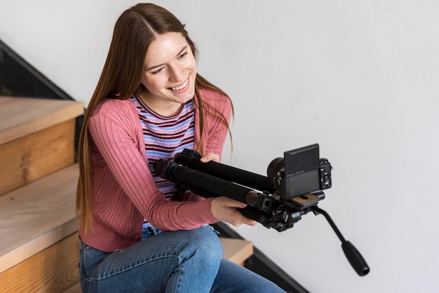 Blogger holding tripod with camera