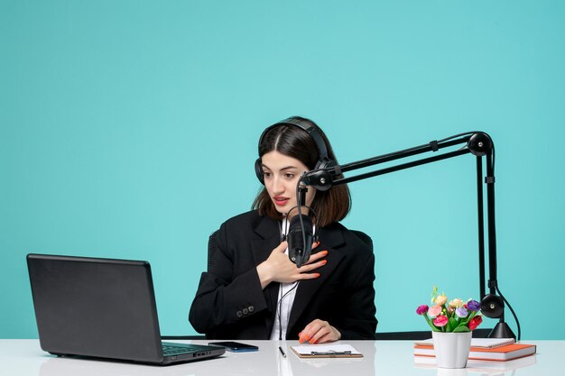 Blogger journalist brunette cute girl in black blazer recording speech on camera