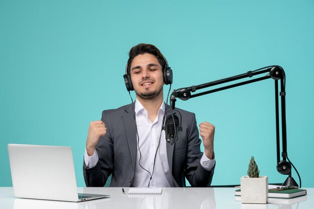 Blogger journalist cute handsome young guy in grey suit recording video excited