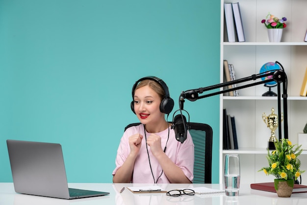 Blogger journalist in office young cute blonde girl recording video on computer excited