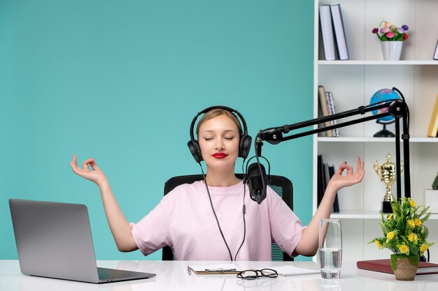 Blogger journalist in office young cute blonde girl recording video on computer