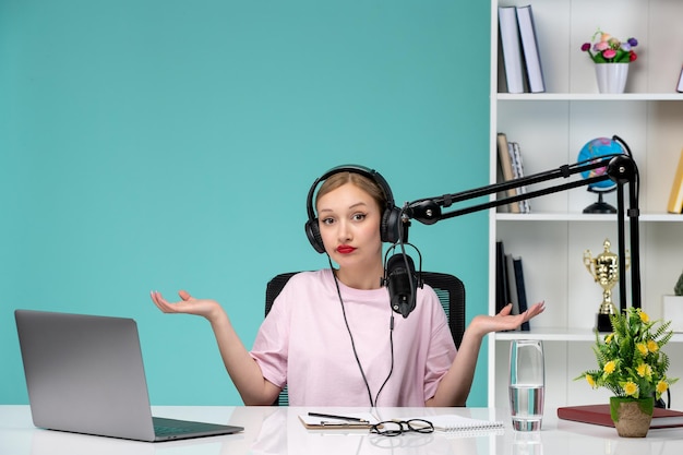 Free photo blogger journalist pretty cute blonde girl recording video on computer waving hands