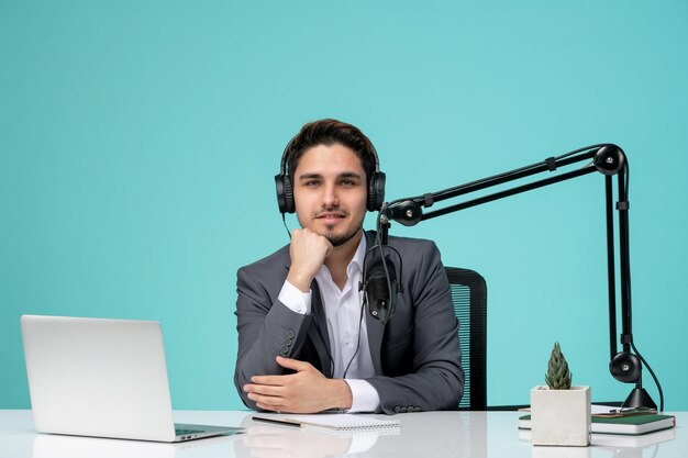 Blogger journalist pretty cute handsome guy recording video in grey suit smiling