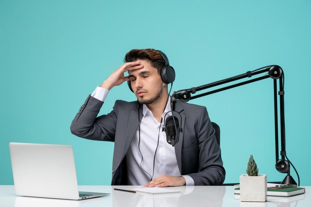 Blogger journalist pretty cute handsome guy recording video in grey suit very tired