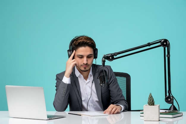 Blogger journalist pretty cute handsome guy recording video in grey suit