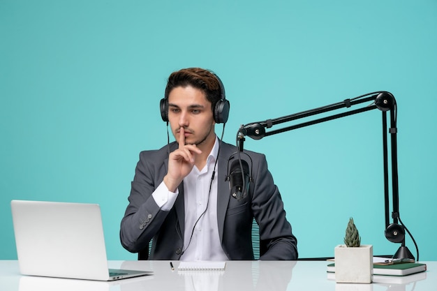 Blogger journalist recording video cute handsome guy in office silence sign