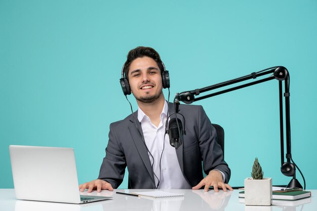 Blogger journalist young cute handsome guy in grey suit recording video proud