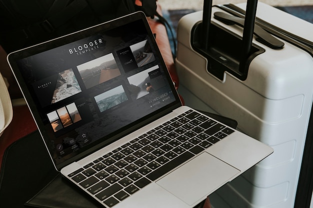 Blogger laptop by a luggage at the airport