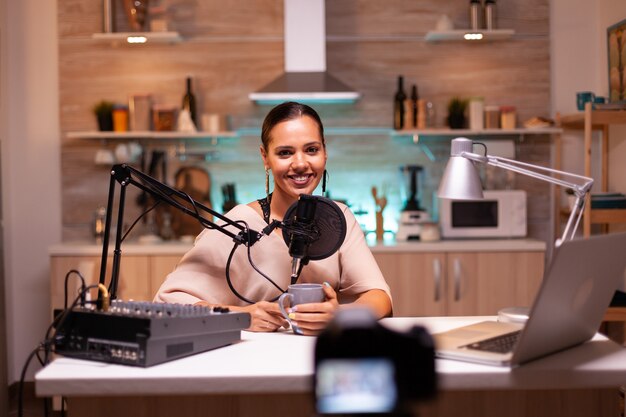 Blogger looking while recording video and speaking on microphone