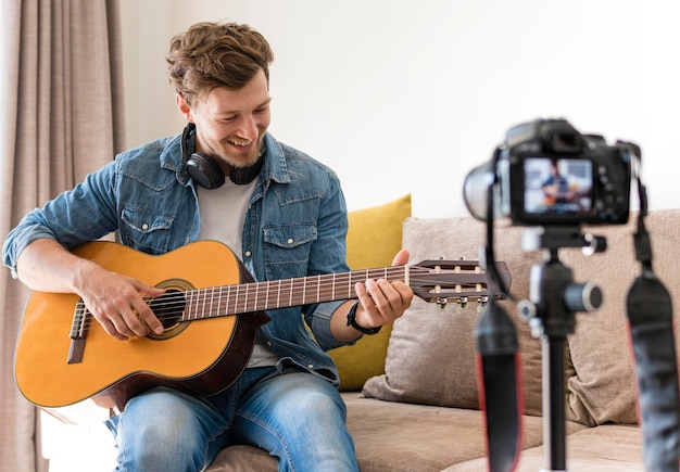 Blogger playing guitar on camera