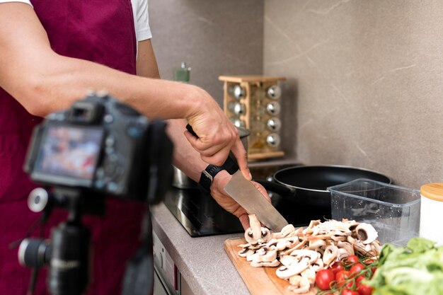 Blogger recording cooking video at home