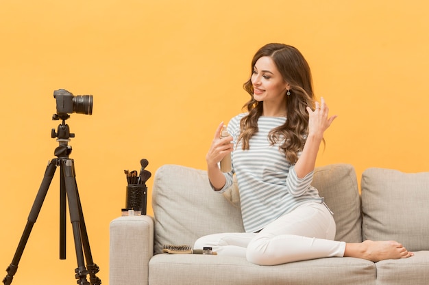 Blogger recording for personal blog on the couch